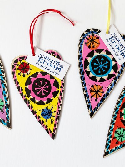 colourful lino cut printed wooden folk hearts