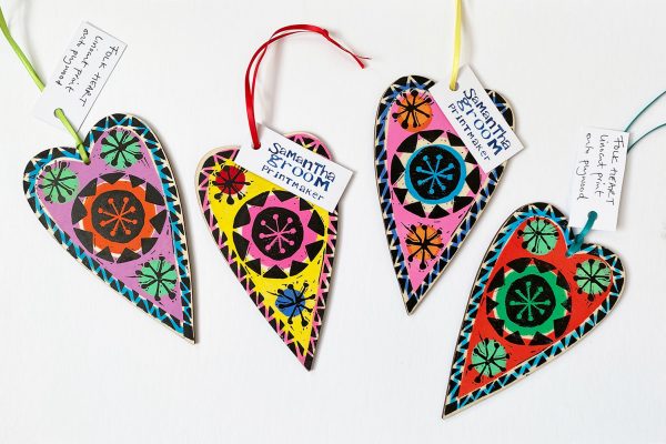 colourful lino cut printed wooden folk hearts