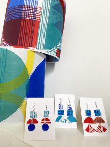 Statement earrings and woodcut printed abstract lampshades together