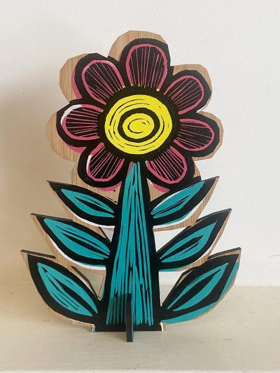 Green and yellow linocut printed flower on bamboo