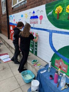 Two young helpers painting my mural