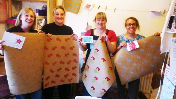 Ladies smiling and holding up their printed work