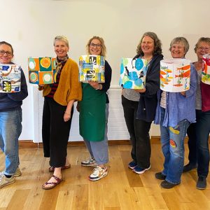ladies smiling and holding up their lampshades worrall hall