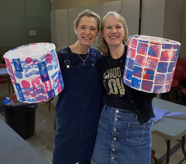 two ladies smiling and holding up their finished hand printed lampshades