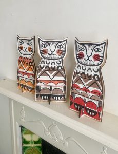 Ginger cats in a row one looking